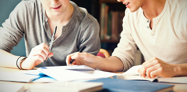 A tutor goes through work with a student